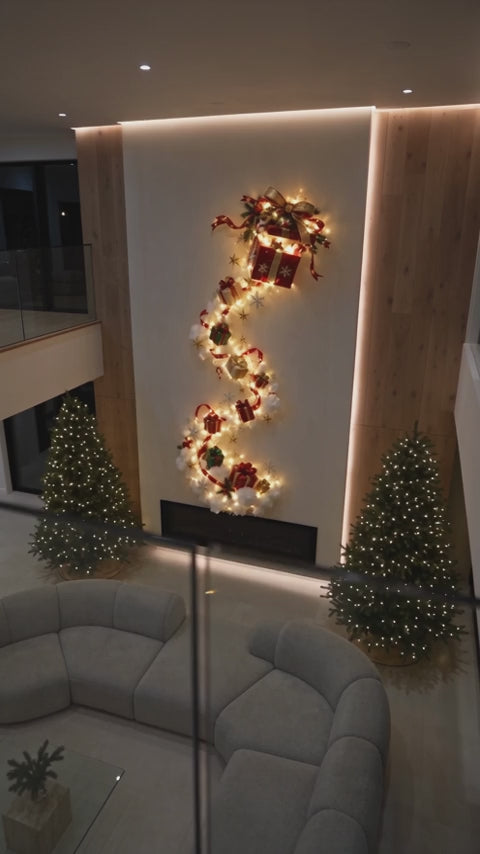 Gift Cascade wall light glowing in a panelled double-height room